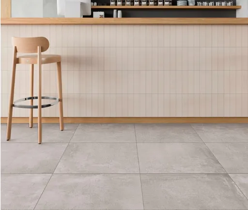 Barhocker aus Holz neben einer Arbeitsplatte auf einem DryTile-Fliesenboden in neutraler Umgebung.