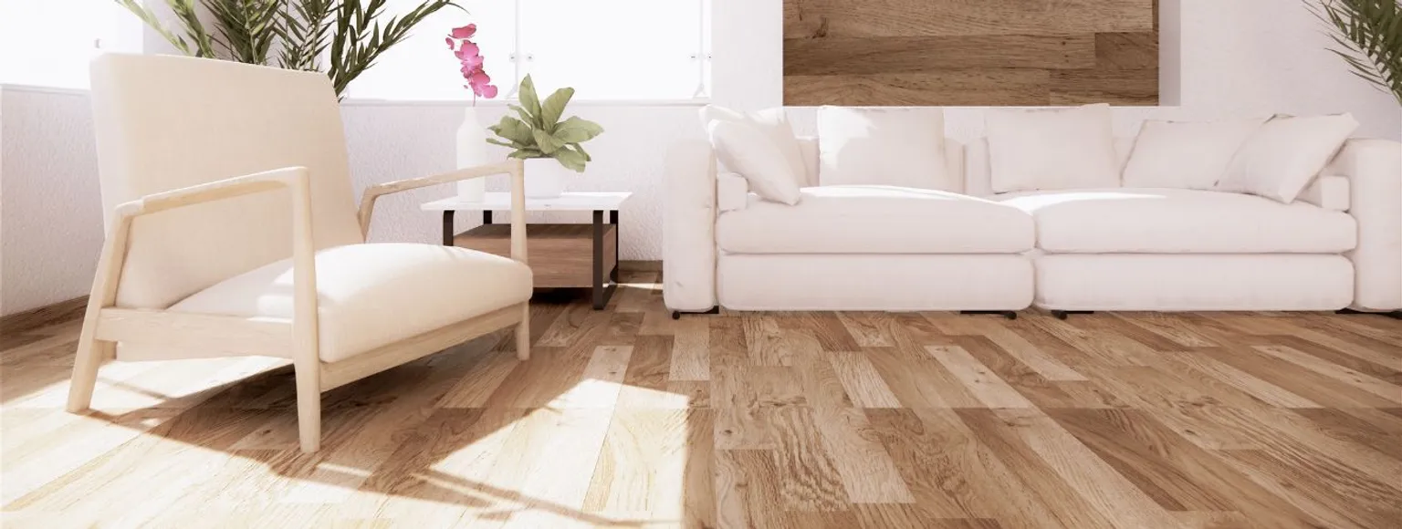 Wohnzimmer mit hellem Parkettboden, weißem Sofa, Sessel und großen Fenstern.