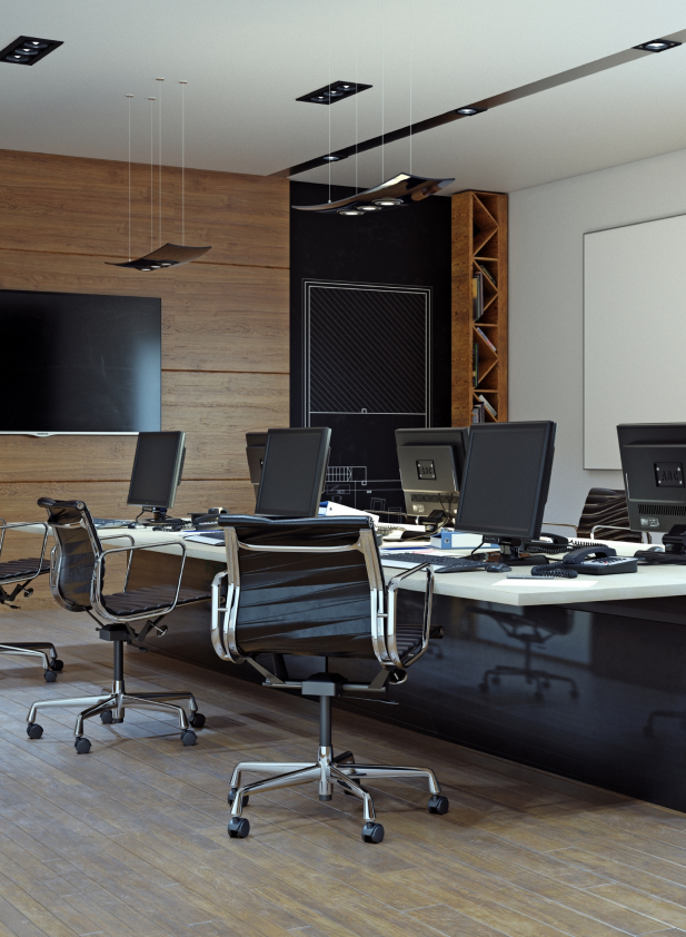 Moderne Büroeinrichtung mit Holzakzenten, Computern und neutralem Bodenbelag im Arbeitsbereich.