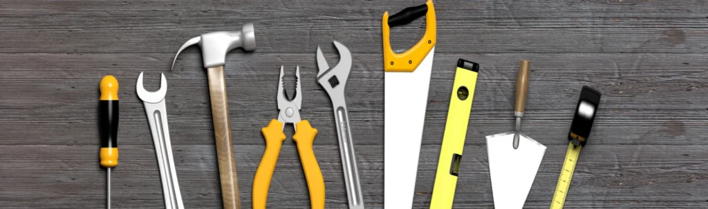 Handwerkzeuge wie Hammer, Säge und Schraubenschlüssel.